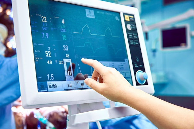 Photo monitoring patient's vital sign in operating room. doctor cheking at patient's vital signs. cardiogram monitor during surgery in operation room.