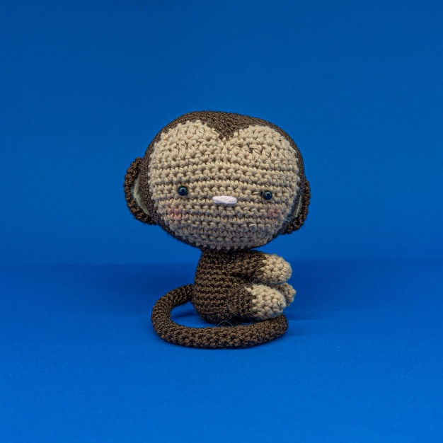 Monkey amigurumi on blue background