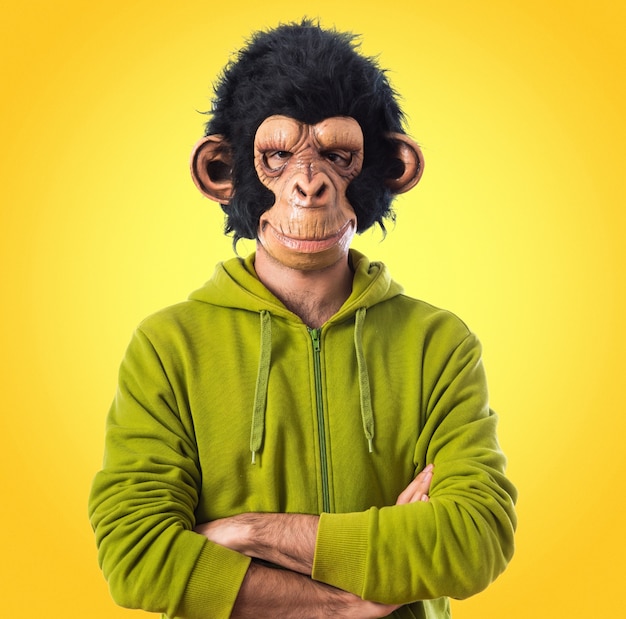 Monkey man with his arms crossed  on colorful background