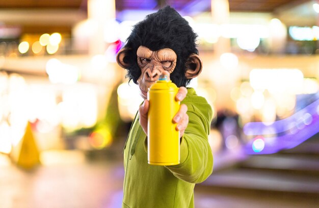 Photo monkey man with spray on unfocused background