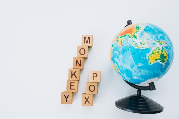 MONKEYPOX Woord geschreven op vierkante houten tegels met een witte achtergrond Zoönotische virale ziekte