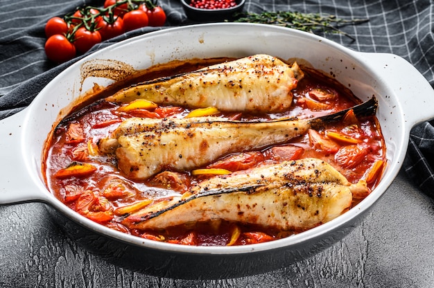 Monkfish baked in tomatoes in a baking plate