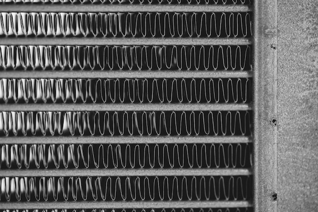 Monochrome automotive radiator close up.