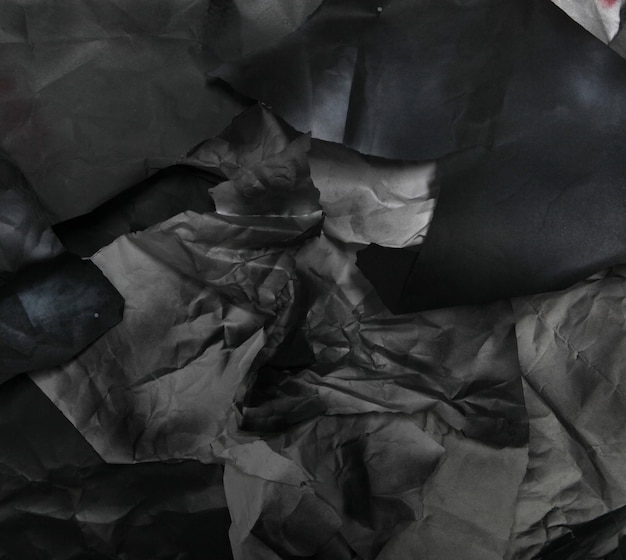 Monochrome background of torn pieces of black and white paper