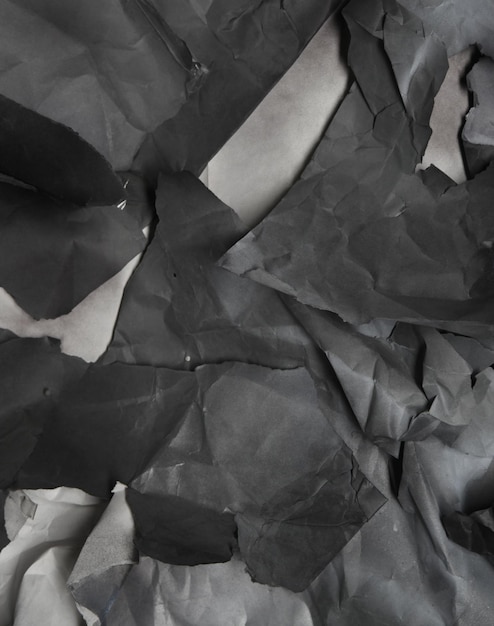 Monochrome background of torn pieces of black and white paper