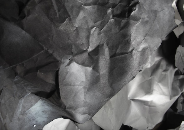 Monochrome background of torn pieces of black and white paper
