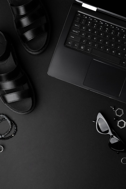 Monochrome composition with laptop, clothing and accessories