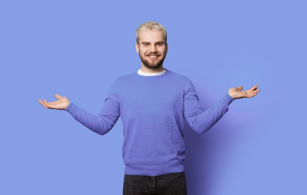 Monochrome photo of a bearded man with blonde hair comparing two things on his palms