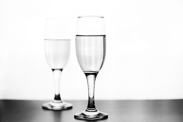 monochrome photo of champagne on white table on white background isolate