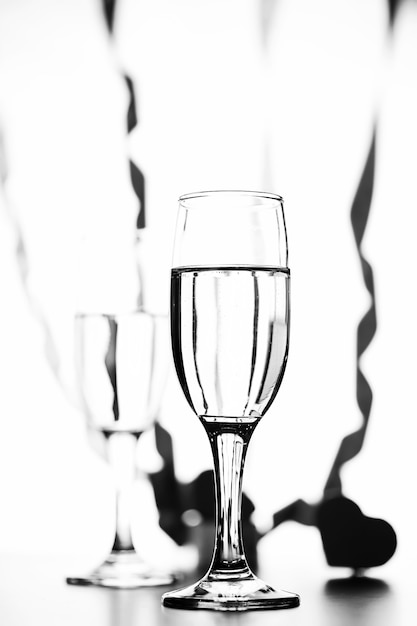 Monochrome photo of champagne on white table on white background isolate