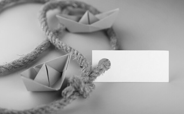 Monochrome photo sticker with thick braided rope and ship paper origami