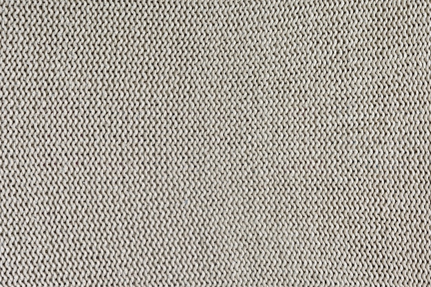 사진 뜨개질의 흑백 질감입니다. 루프와 아름 다운 배경입니다. 편물은 밝은 베이지 색이다.