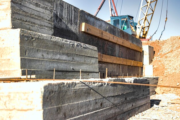 Photo monolithic reinforced concrete foundation for the construction of a residential building rostverk at the construction site construction pit with foundation after formwork removal