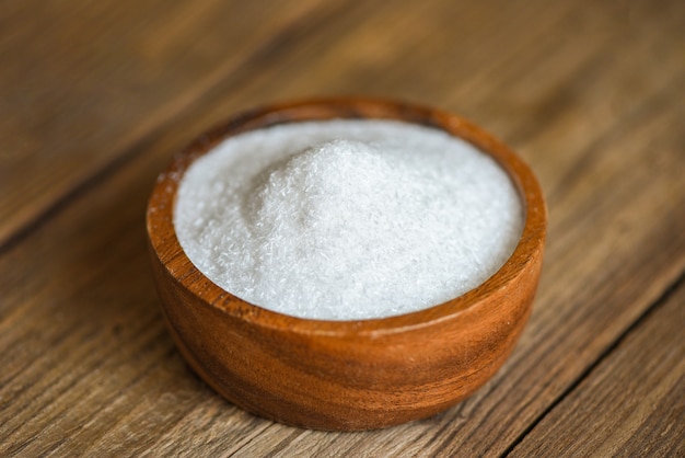 Monosodium glutamate on wooden bowl on the table