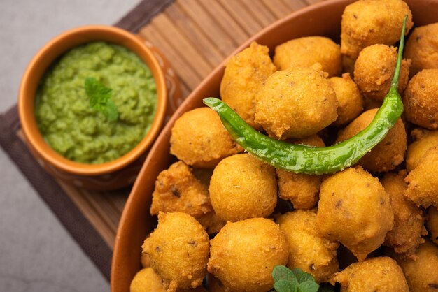 Monsoon special Moong Dal Vada, Pakoda, Dalwada, Pakora or Mungdal Bhajiya or Yellow Split Gram Fritters Served with Green Chutney