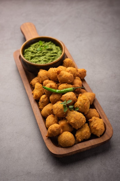 Monsoon special Moong Dal Vada, Pakoda, Dalwada, Pakora or Mungdal Bhajiya or Yellow Split Gram Fritters Served with Green Chutney