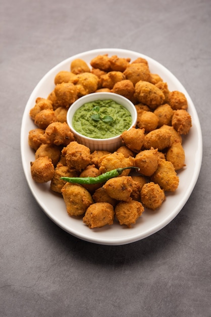 Monsoon special Moong Dal Vada, Pakoda, Dalwada, Pakora or Mungdal Bhajiya or Yellow Split Gram Fritters Served with Green Chutney