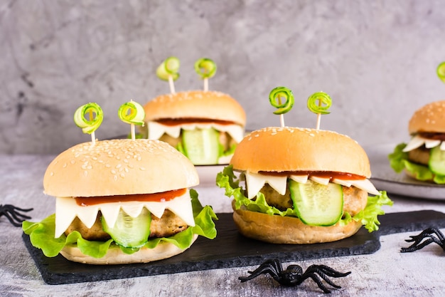 Monster burgers for halloween menu on slate and spiders home\
made creative food