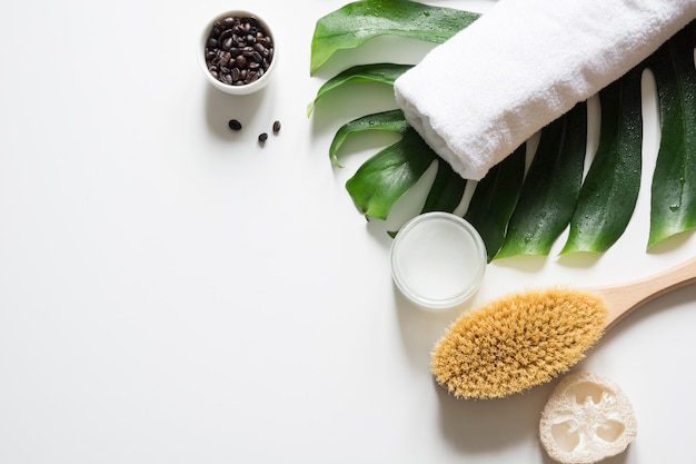 Monstera leaf, brush, coffee beans, SPA set for wellness . Copy space.