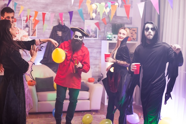 Photo monsters at a halloween celebration drinking alcohol.