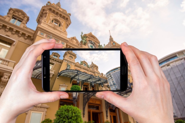 Monte Carlo, Monaco. Facade of the Grand Casino in Monte Carlo. tourist takes a photo