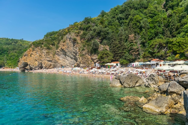 MONTENEGRO BUDVA tourists swim on the Mogren beach in the hot season