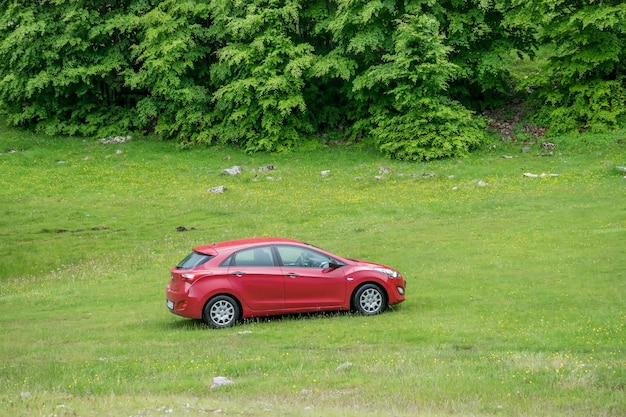 MONTENEGRO the car is parked by tourists on the roadside of serpentine for sightseeing