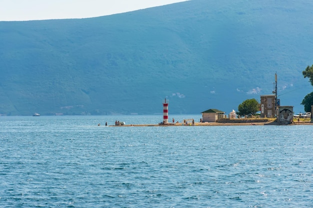 Montenegro kamenari locals bathe on the beach near the lighthouse