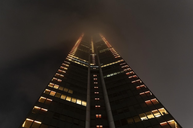 Montparnasse tower at night with fog