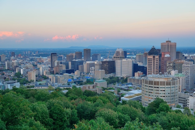 Montreal city skyline at sunset viewed from Mont Royal with urban skyscrapers.