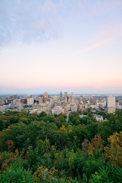 Montreal city skyline at sunset viewed from Mont Royal with urban skyscrapers.