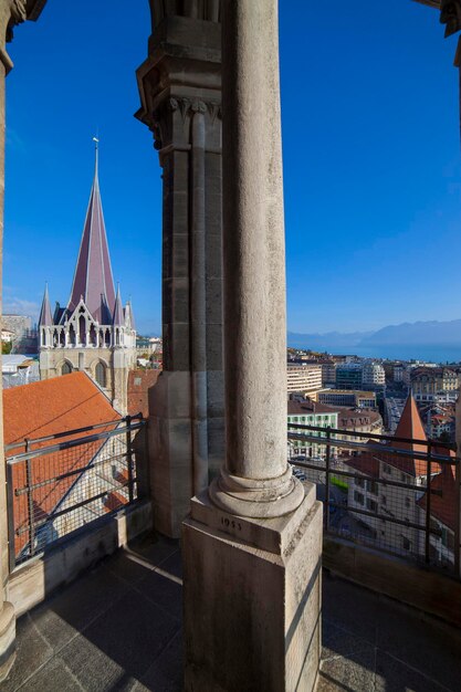 Monument in city against clear blue sky