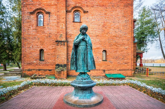 Monument to Tsarevich Dmitry near the ancient chambers in the Uglich Kremlin in the early autumn morning