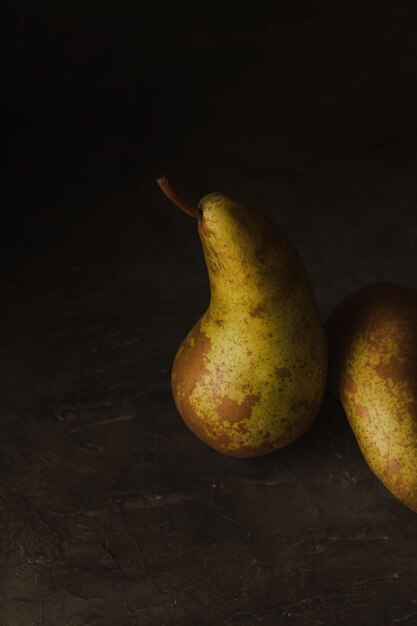 Moody shot of pears against dark background