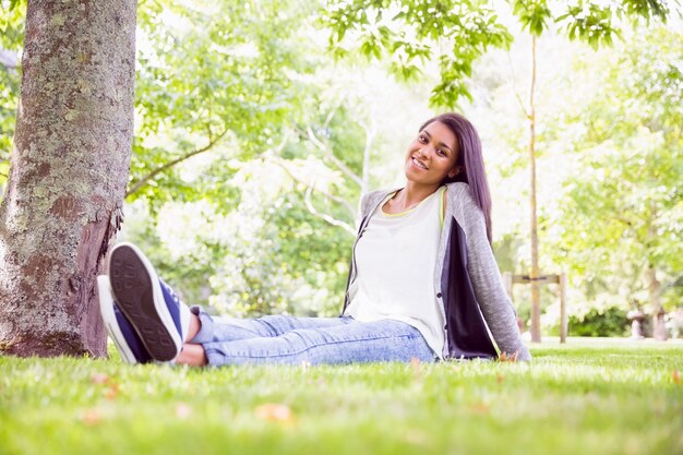 Foto mooi brunette die bij camera in park glimlachen