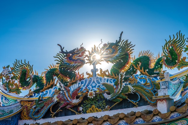 Mooi Elegant dubbel gouden draakstandbeeld op het dak van een tempel voor Chinees Nieuwjaarfestival bij Chinees heiligdom met blauwe hemel
