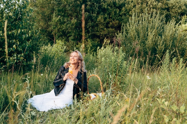 Mooi jong meisje dat op een picknick in de zomer rust.