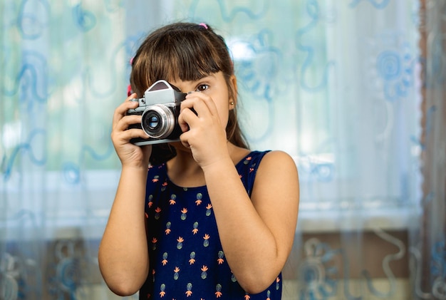 mooi meisje dat foto's maakt met een oude camera