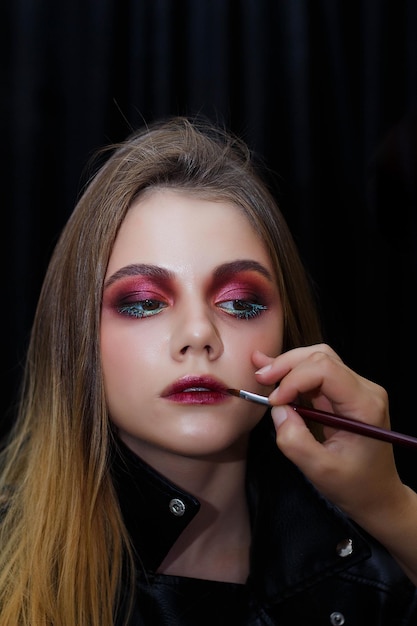 Mooi meisje doet make-up make-up artiest werk make-up concept