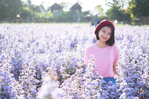 Mooi meisje met paarse Marguerite bloemen