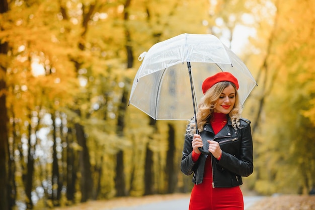 Mooi meisje met paraplu in herfstpark