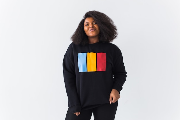 Mooie african american vrouw poseren in zwart sweatshirt op wit