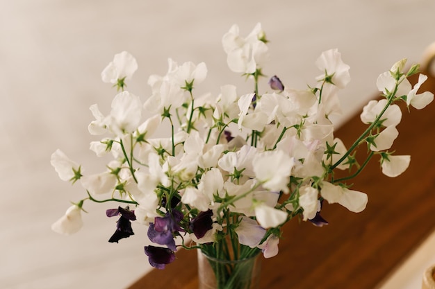 Mooie bloemen in glazen vazen sieren de open haard in huis