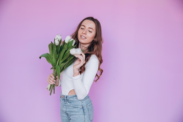 Mooie blonde krijgt een boeket bloemen voor de voorjaarsvakantie. Feestelijk concept