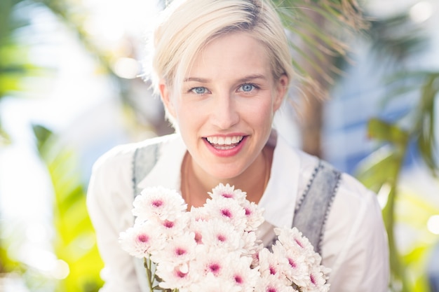 Mooie blonde vrouw met bos bloemen