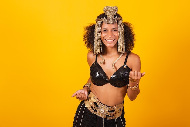 Mooie Braziliaanse zwarte vrouw in Cleopatra carnaval kleren uitnodigend met handen