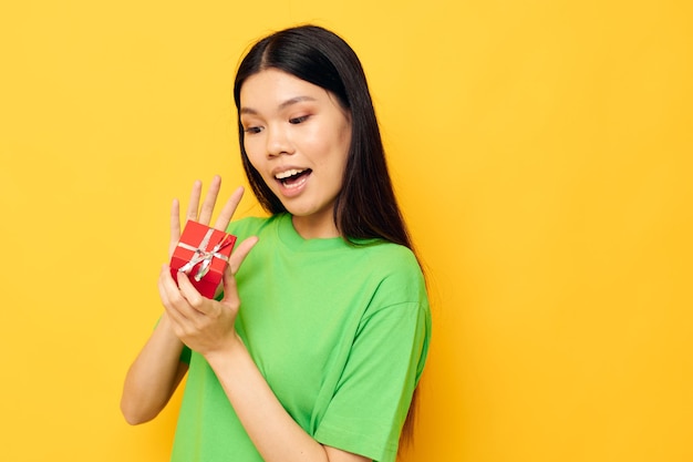 Mooie brunette in groene t-shirts met een onveranderde levensstijl in een kleine geschenkdoos