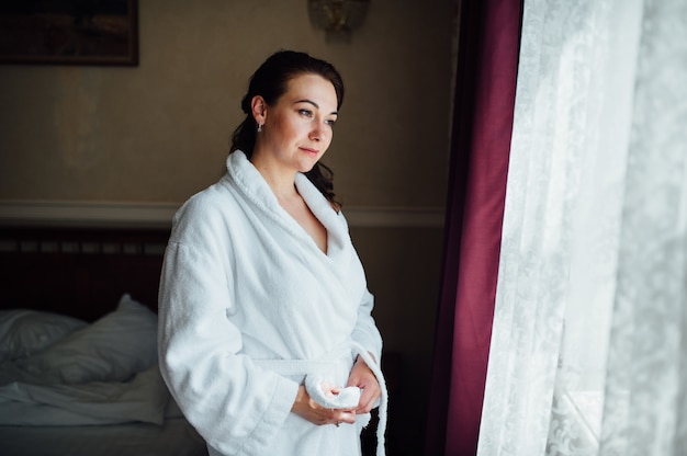 Mooie brunette meisje in een hotelkamer