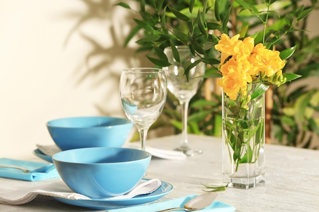 Mooie feestelijke tafelschikking en vaas met bloemen in lichte kamer