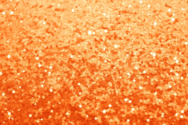 Foto mooie glanzende oranje glitter als achtergrond close-up